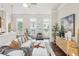 Stylish living room featuring a cozy sofa, modern decor, and ample natural light from large windows at 306 Masons Row, Marietta, GA 30060