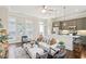 Open-concept living area with kitchen island, contemporary design, and inviting atmosphere at 306 Masons Row, Marietta, GA 30060
