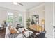 Bright living room with large windows, hardwood floors, stylish decor, and neutral-toned furniture at 306 Masons Row, Marietta, GA 30060