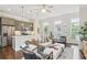 Open-concept living area with a modern kitchen, comfortable seating, and large windows at 306 Masons Row, Marietta, GA 30060