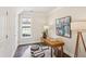 Home office with a wooden desk, stylish ottomans, and natural light from a window at 306 Masons Row, Marietta, GA 30060