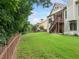 Large backyard with green lawn and a wood fence at 3157 Perimeter Cir, Buford, GA 30519