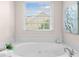 Inviting soaking tub with a view of the yard at 3157 Perimeter Cir, Buford, GA 30519