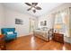 Comfortable bedroom featuring hardwood floors, a trundle bed, a blue armchair and natural light from the window at 3157 Perimeter Cir, Buford, GA 30519