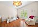 Bright bedroom with hardwood floors, a twin bed, a cozy armchair and natural light from the window at 3157 Perimeter Cir, Buford, GA 30519