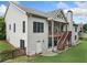 Exterior angle of house showcasing back deck, covered patio, backyard, and light colored siding at 3157 Perimeter Cir, Buford, GA 30519