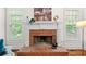 Fireplace with brick surround, white mantel and hearth at 3157 Perimeter Cir, Buford, GA 30519
