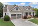 Charming single-Gathering home with a two-car garage, manicured lawn, and a classic facade under a cloudy sky at 3157 Perimeter Cir, Buford, GA 30519