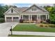 Charming single-Gathering home featuring a large front porch, two-car garage, and beautifully landscaped front yard at 3157 Perimeter Cir, Buford, GA 30519