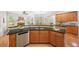 Bright kitchen features stainless steel appliances, granite countertops and views to the living room and fireplace at 3157 Perimeter Cir, Buford, GA 30519