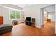 Inviting living room featuring laminate flooring, a window with natural light and an open doorway at 3157 Perimeter Cir, Buford, GA 30519