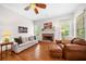 Cozy living room with a fireplace, hardwood floors, and comfortable seating at 3157 Perimeter Cir, Buford, GA 30519