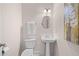 Cozy powder room with pedestal sink, mirror, and toilet at 3157 Perimeter Cir, Buford, GA 30519