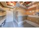 Unfinished basement area featuring shelving and access door at 4228 Lakes End Nw Dr, Kennesaw, GA 30144