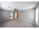 Spacious bedroom with neutral carpet, natural light, and a walkthrough to the bathroom at 4228 Lakes End Nw Dr, Kennesaw, GA 30144