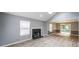 Spacious living room features a cozy fireplace, light-filled windows, and sleek flooring at 4228 Lakes End Nw Dr, Kennesaw, GA 30144