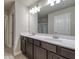 Modern bathroom featuring double vanity sinks, a large mirror, and plenty of cabinet space at 45 Avian Way, Auburn, GA 30011