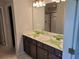 Bathroom featuring double vanity with large mirror and glass shower door at 45 Avian Way, Auburn, GA 30011