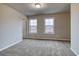 Cozy bedroom with plush carpet, neutral walls, and windows providing natural light and scenic views at 45 Avian Way, Auburn, GA 30011
