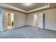 Spacious bedroom featuring plush carpet, neutral paint, and ample natural light from a nearby doorway at 45 Avian Way, Auburn, GA 30011