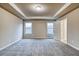 Bright bedroom with neutral walls and carpet, and windows allowing natural light, creating a warm atmosphere at 45 Avian Way, Auburn, GA 30011