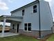 Exterior rear elevation showcasing siding and covered patio with brick foundation at 45 Avian Way, Auburn, GA 30011