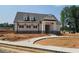 New construction home featuring a charming covered porch and modern finishes at 45 Avian Way, Auburn, GA 30011