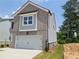 Charming two-story home with brick and siding exterior and a two-car garage at 45 Avian Way, Auburn, GA 30011