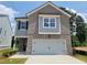 Charming two-story home with brick and siding exterior and a two-car garage at 45 Avian Way, Auburn, GA 30011