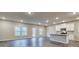 Bright, open kitchen featuring white cabinets, stainless steel appliances, a center island, and wood-look floors at 45 Avian Way, Auburn, GA 30011