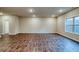 Spacious living room with wood-look floors, recessed lighting, and a large window offering plenty of natural light at 45 Avian Way, Auburn, GA 30011