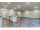 Open living space with wood-look floors, recessed lighting, and a kitchen island with sink and stainless appliances at 45 Avian Way, Auburn, GA 30011