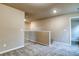 Neutral loft space featuring plush carpeting, bright lighting, and an open view of the floor below at 45 Avian Way, Auburn, GA 30011