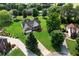 A beautiful aerial view of a house sitting on a large, landscaped lawn surrounded by mature trees at 16 Kentucky Ne Walk, Cartersville, GA 30121