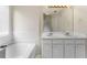 Bright bathroom features a soaking tub under a window and double sinks at 16 Kentucky Ne Walk, Cartersville, GA 30121