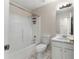 A clean bathroom with a tub and shower combo, alongside a sink and white cabinets at 16 Kentucky Ne Walk, Cartersville, GA 30121