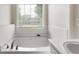 Bright bathroom with a soaking tub and a large window at 16 Kentucky Ne Walk, Cartersville, GA 30121