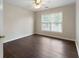 A cozy bedroom featuring dark wood floors and a ceiling fan for added comfort at 16 Kentucky Ne Walk, Cartersville, GA 30121