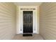 Close up on front door with sidelights, enhanced by a welcoming wreath, and complementary hardware at 16 Kentucky Ne Walk, Cartersville, GA 30121