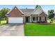Charming single-Gathering home boasts a manicured lawn, two-car garage, and classic brick and siding facade at 16 Kentucky Ne Walk, Cartersville, GA 30121