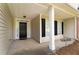 Inviting front porch featuring classic columns, dark shutters, and a 'Welcome' sign for guests at 16 Kentucky Ne Walk, Cartersville, GA 30121
