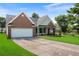 Well-maintained single-story home with brick accents, a two-car garage, and lush green front yard at 16 Kentucky Ne Walk, Cartersville, GA 30121
