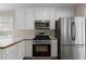 This modern kitchen is equipped with stainless steel appliances and updated cabinetry at 16 Kentucky Ne Walk, Cartersville, GA 30121