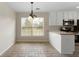 Bright eat-in kitchen features a window, neutral countertops, and tiled floors at 16 Kentucky Ne Walk, Cartersville, GA 30121