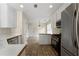 Updated kitchen with stainless steel appliances, white cabinetry, and a view into the adjoining dining area at 16 Kentucky Ne Walk, Cartersville, GA 30121