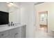 Bathroom featuring marble countertop vanity and decorative mirror at 165 Breakspear Ln, Fayetteville, GA 30214