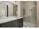 Sleek bathroom with glass-enclosed shower, marble countertop, modern fixtures and gold hardware at 165 Breakspear Ln, Fayetteville, GA 30214