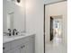 Bathroom featuring marble countertop vanity and decorative mirror at 165 Breakspear Ln, Fayetteville, GA 30214