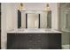 Modern bathroom vanity with double sinks, marble countertop, gold fixtures, and stylish light fixtures at 165 Breakspear Ln, Fayetteville, GA 30214