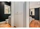 Bedroom with a modern en-suite bathroom featuring a sliding door, and black accent wall paint at 165 Breakspear Ln, Fayetteville, GA 30214